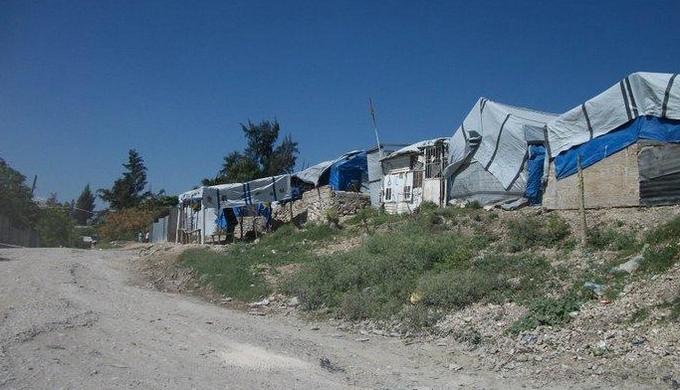 group of tarp covered shacks